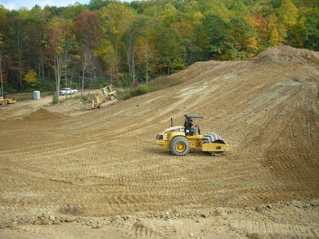 HALL employee compacting the dirt after completing the Broyhill Dam project