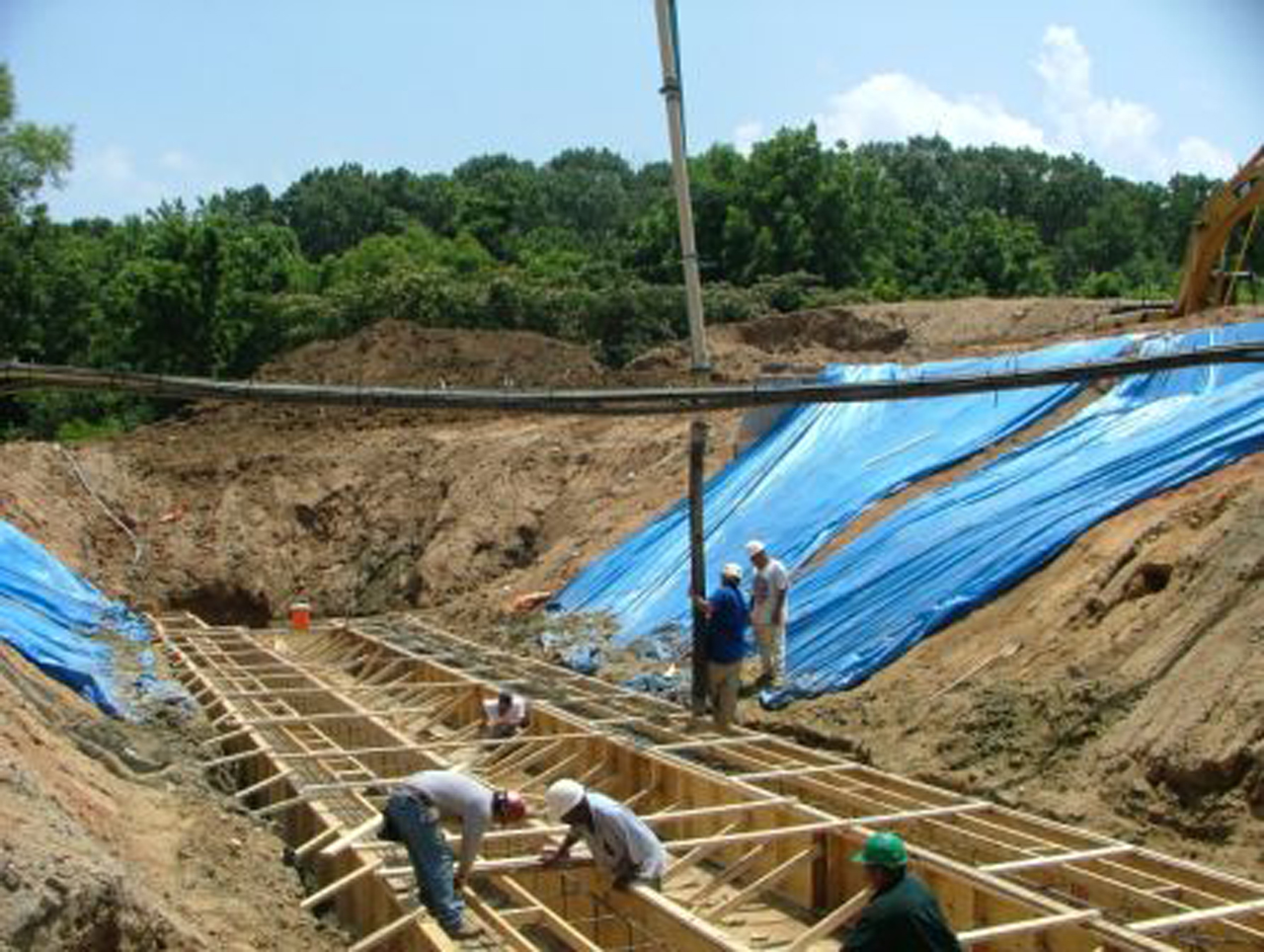 HALL employees working on building a tunnel in Concord, NC with blue tarp laid out